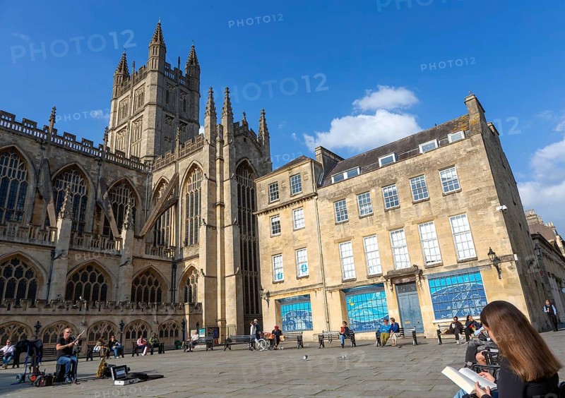 Busker musician performing in Bath Abbey church yard, city of Bath, north east Somerset, England, UK