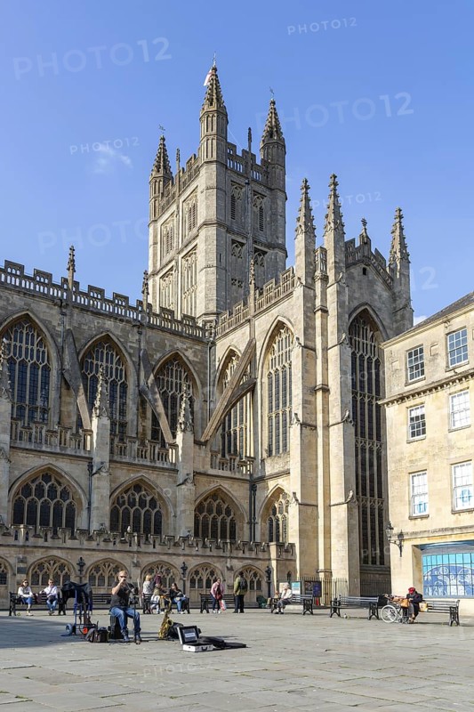 Busker musician performing in Bath Abbey church yard, city of Bath, north east Somerset, England, UK