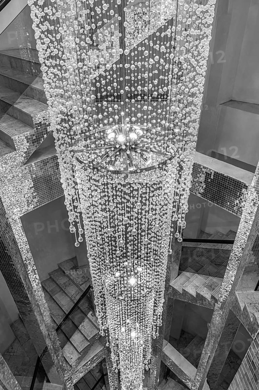 Lamp decorated with glass beads in the stairwell, black and white photo, Wat Phra That Sorn Kaew Buddhist temple complex, Phetchabun province, Thailand