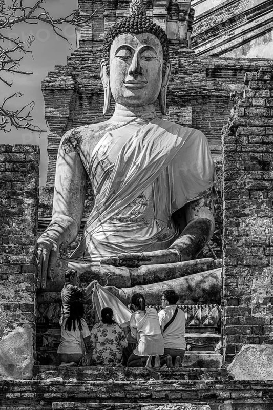 Stone Buddha statue, historic Buddhist temple complex, black and white photo, Ayutthaya, Thailand