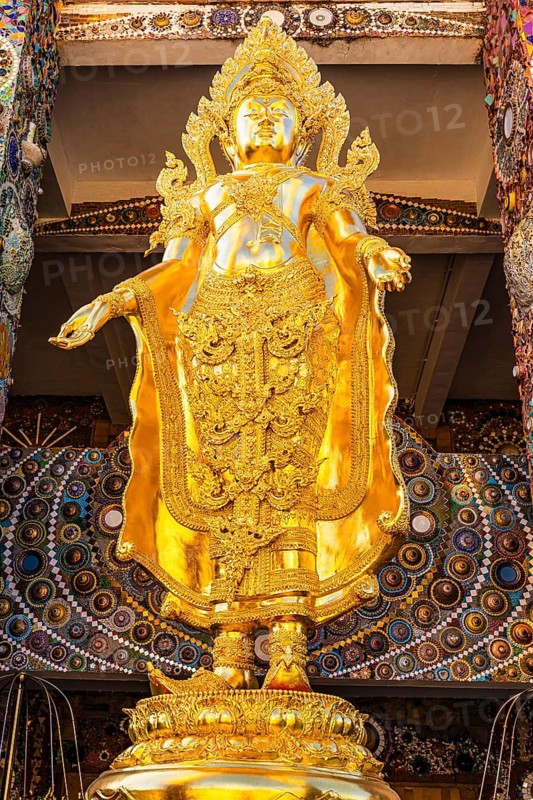 Gilded Buddha statue standing on a gilded base, Buddhist temple complex Wat Phra That Sorn Kaew, Phetchabun province, Thailand
