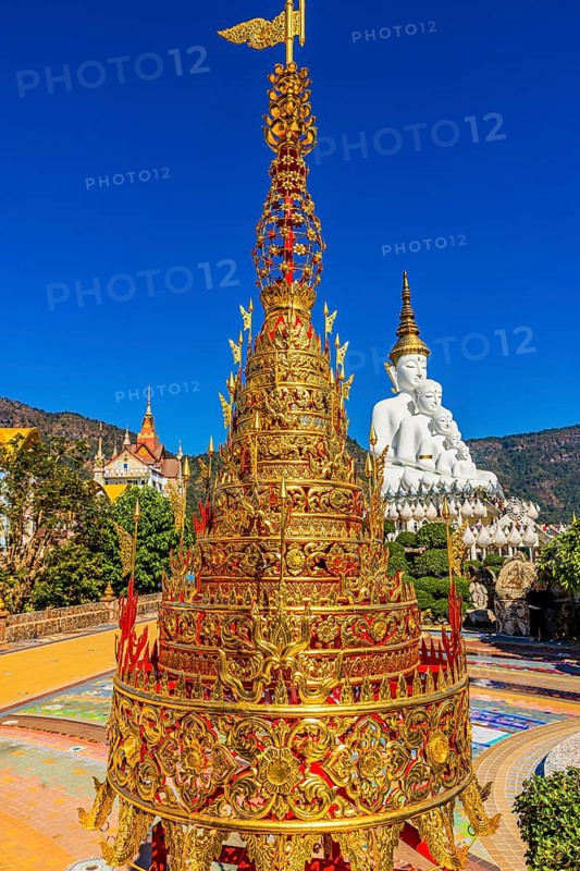 Gilded chedi, the five-headed Buddha statue in the back, Wat Phra That Sorn Kaew Buddhist temple complex, Phetchabun province, Thailand