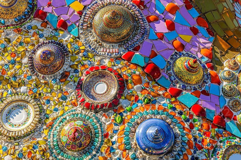 Wall covering with colorful mosaic tiles and incorporated bowls, Buddhist temple complex Wat Phra That Sorn Kaew, Phetchabun province, Thailand