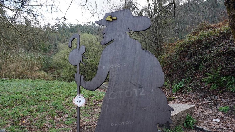 Wooden figure of a pilgrim on the side of the Camino de Santiago, pilgrims on the Caminho Portugues, Portugal, Spain