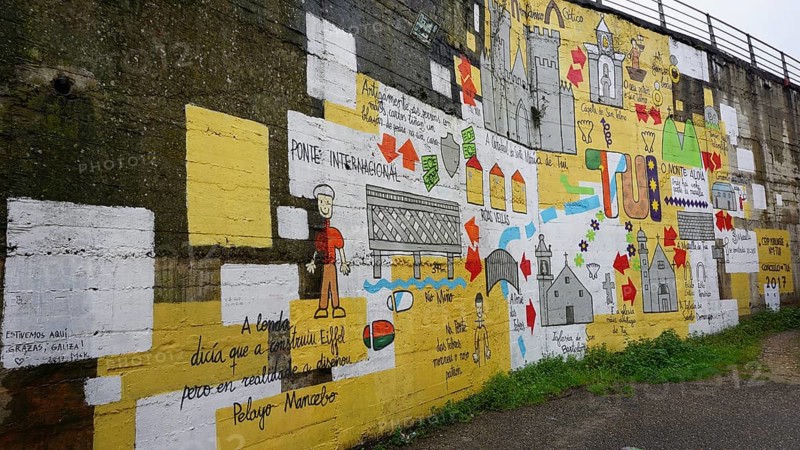 Large-scale wall painting with colorful symbols and texts depicting the Camino de Santiago on the Caminho Portugues, Portugal, Spain