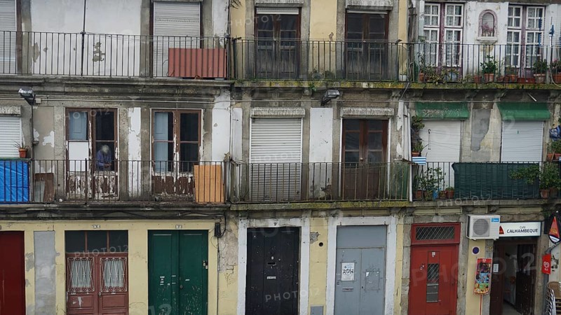 Façade of an old building with several balconies and shutters, Porto, Portugal