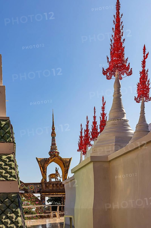 Red decorated tops of a temple complex, Buddhist temple complex Wat Phra That Sorn Kaew, Phetchabun province, Thailand