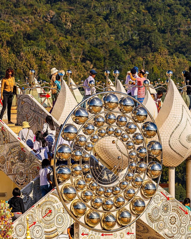 Visitors on the pedestal structure of the five-headed Buddha statue, Wat Phra That Sorn Kaew Buddhist temple complex, Phetchabun province, Thailand