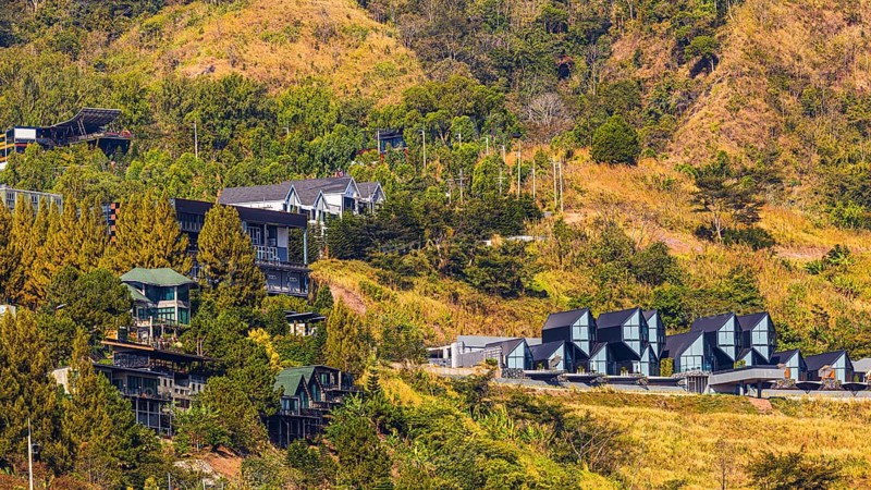 Residential complex with modern residential buildings, behind the Wat Phra That Sorn Kaew Buddhist temple complex, Phetchabun province, Thailand