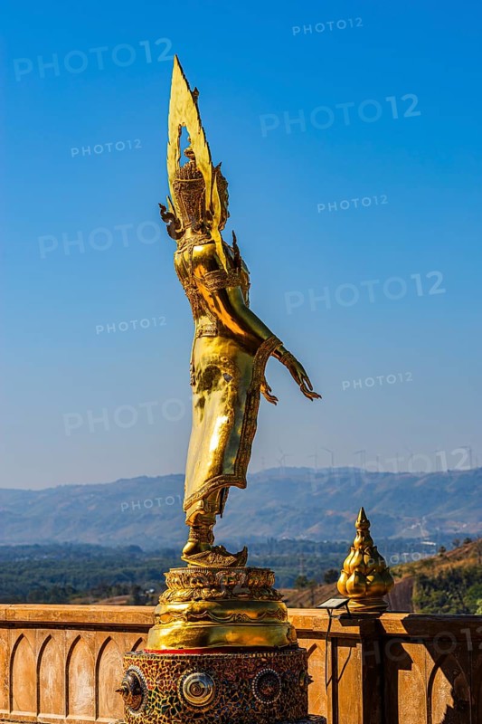 Standing gilded Buddha statue on a viewing terrace, Wat Phra That Sorn Kaew Buddhist temple complex, Phetchabun province, Thailand