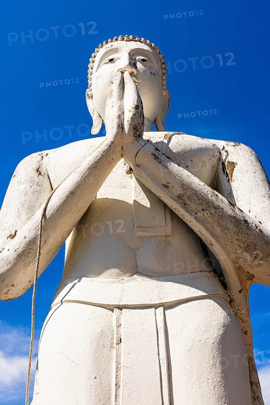 Stone praying white Buddha statue, historic Buddhist temple complex, Ayutthaya, Thailand
