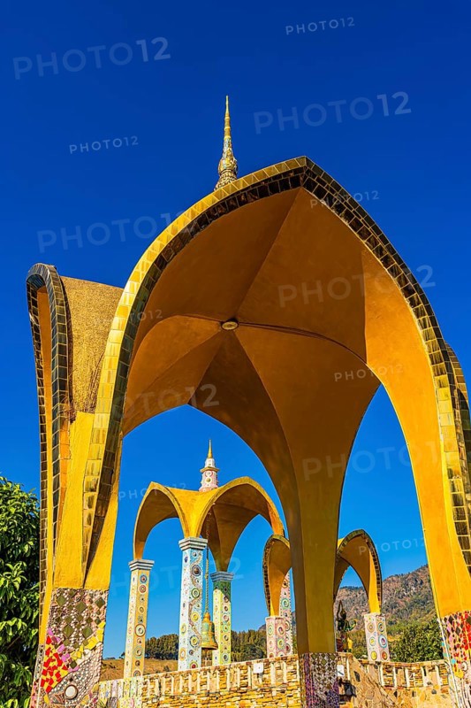 Round arch pavilions decorated with colorful mosaics and glass works of art, Buddhist temple complex Wat Phra That Sorn Kaew, Phetchabun province, Thailand