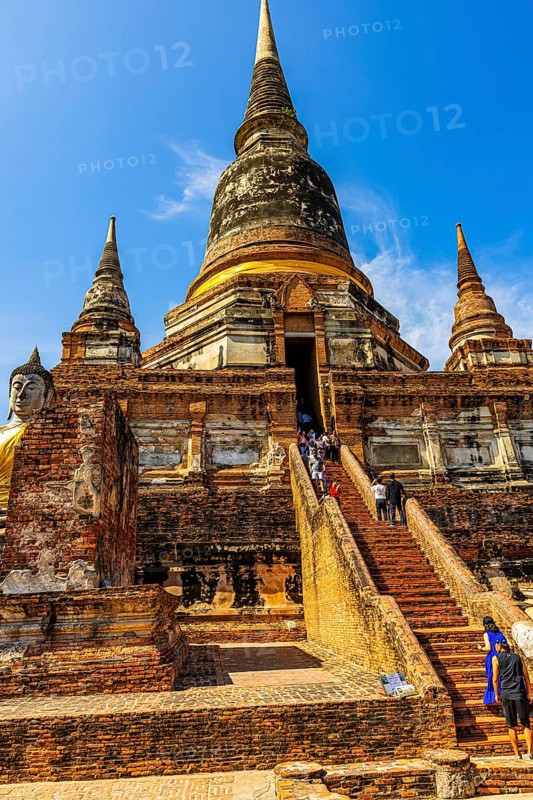 Visitors on steep stairs to the entrance of a temple tower, Prang, historic Buddhist temple complex, Ayutthaya, Thailand