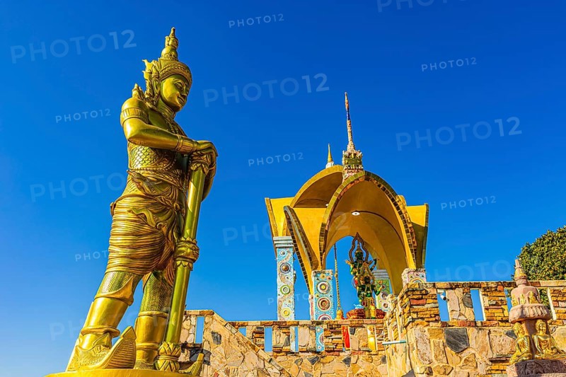 Round arch pavilions decorated with colorful mosaics and glass works of art, in front of a gilded temple guard, Buddhist temple complex Wat Phra That Sorn Kaew, Phetchabun province, Thailand
