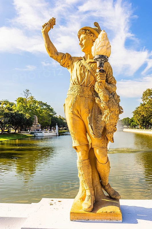 Stone male figure in alpine traditional costume, Thai King's summer palace, Bang Pa-In, near Ayutthaya, Thailand