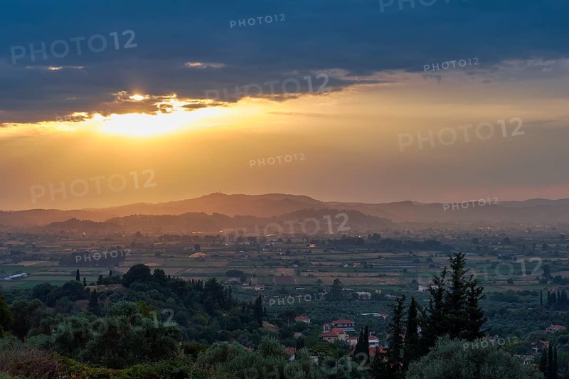 Panoramic view of a peaceful landscape at sunset with lush vegetation, Hotel Europa, garden restaurant and view of the surrounding landscape, Olympia, Peloponnese, Greece
