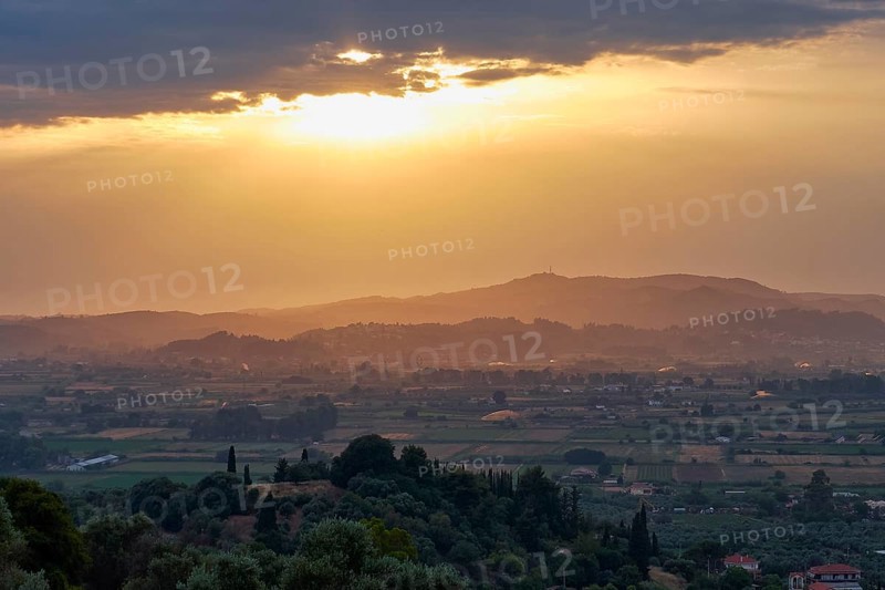 Impressive evening mood with sweeping views over fields and hills in the distance, Hotel Europa, garden restaurant and views of the surrounding countryside, Olympia, Peloponnese, Greece