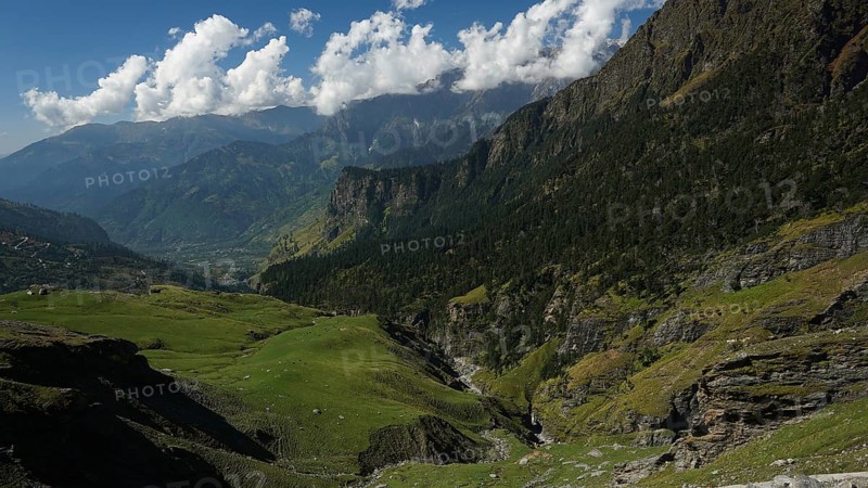 Green valleys and mountains under a partly cloudy sky, trekking in Ladakh, Manali-Leh Highway, Himachal Pradesh, India