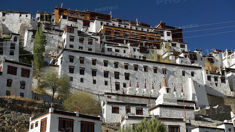 Thiksey monastery, large ensemble of buildings with white walls and windows under blue sky, Indus Valley, trekking in Ladakh, Himalayas, India