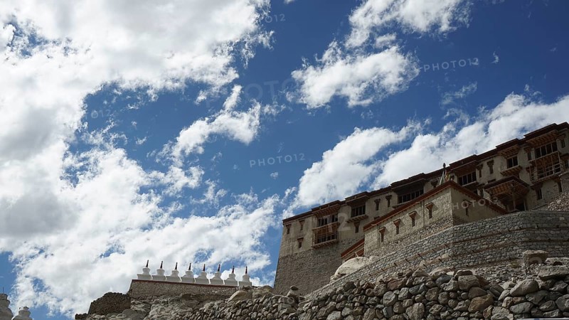 Stone Buddhist monastery building under a dramatic sky full of clouds, trekking in Ladakh, Himalayas, India