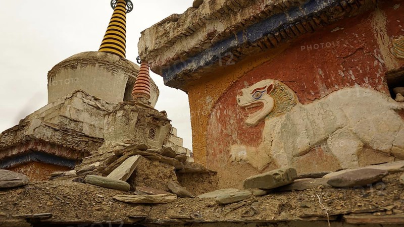 Historic temple wall with lion relief and stupa decoration in an old complex, trekking in Ladakh, Himalayas, India