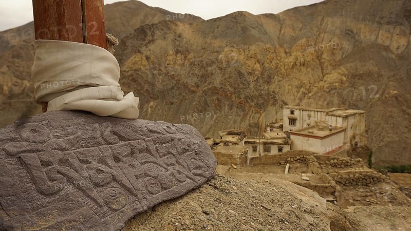 An engraved Mani stone in a mountainous landscape, near an ancient monastery, Leh, trekking in Ladakh, Himalayas, India