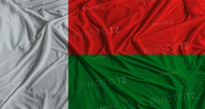Madagascar flag with fabric texture background. National flag of Madagascar with cloth texture
