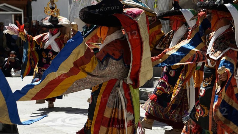 People wearing traditional garments dancing in festive community, Leh, trekking in Ladakh, Himalayas, India