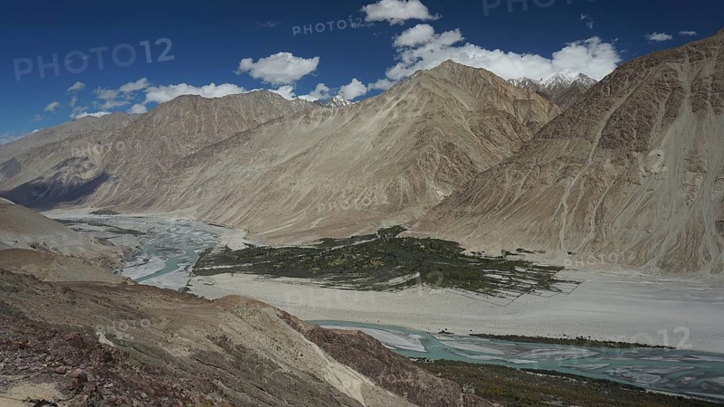 Extensive Nubra Valley with river course and impressive mountains under sunny skies, trekking in Ladakh, Himalayas, India