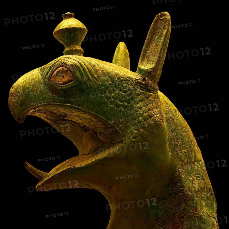 Bronze griffin protome, mystical animal head sculpture made of green material with detailed design, Olympia Archaeological Museum, Ancient Olympia, Olympia, Peloponnese, Greece