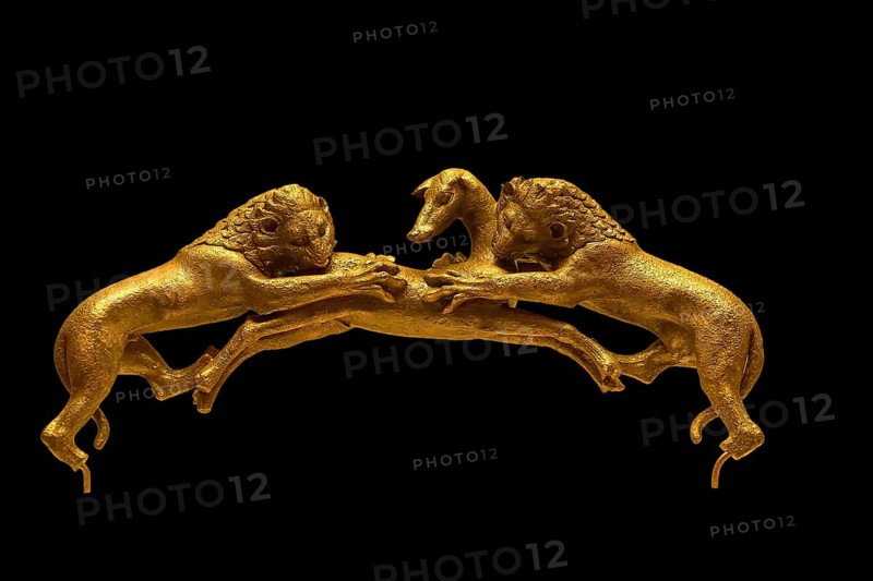 Two golden lions attacking a deer on a dark background, handle of a bronze vessel, Olympia Archaeological Museum, Ancient Olympia, Olympia, Peloponnese, Greece
