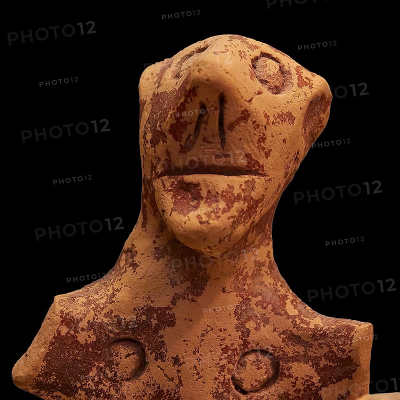 Anthropomorphic votive statuette, clay figure with abstract facial features and antique-looking patina, Olympia Archaeological Museum, Ancient Olympia, Olympia, Peloponnese, Greece
