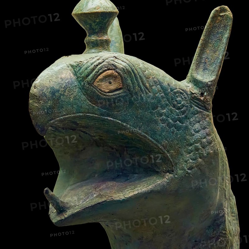 Bronze griffin protome, green-brown bronze depiction of an imaginary being with fine scale patterns, Olympia Archaeological Museum, Ancient Olympia, Olympia, Peloponnese, Greece