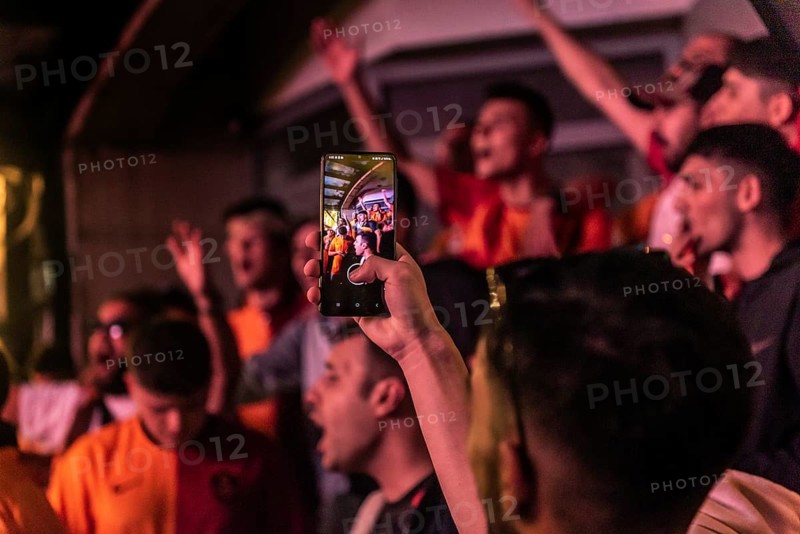 Istanbul, Turkey. October 24th 2023 Galatasaray football fan with a cell phone while chanting songs before the Champions League match against FC Bayern Munich. Nevezade near Istiklal Street, Taksim, Istanbul, Turkey