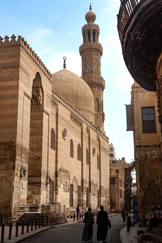 Cairo, Egypt. July 7th 2024 Locals and tourists walk past one of the many restored monuments along Sharia Al Muizz Li Din Allah near Khan El Khalili Bazaar, historical Cairo, Egypt