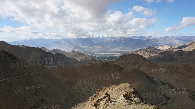 Extensive mountain landscape with sunny skies and stretches of clouds, trekking in Ladakh, Himalayas, India