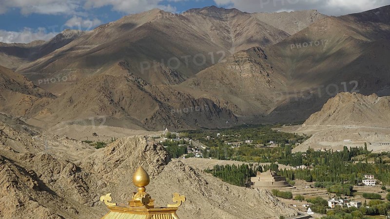 View of a valley with Buddhist buildings and surrounding mountains, trekking in Ladakh, Himalayas, India