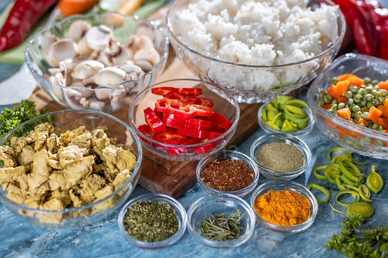 Various fresh ingredients such as peppers, carrots, rice and spices