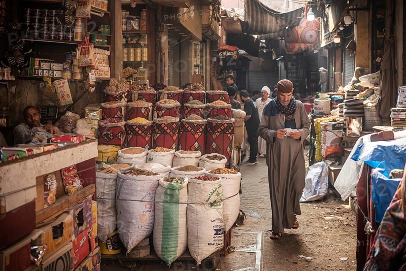 Cairo, Egypt. July 1st 2024 An Egyptian man walking in the narrow streets of the spice market a busy souk popular with locals and tourists near Khan El Khalili Bazaar, Al Hussein, Cairo, Egypt