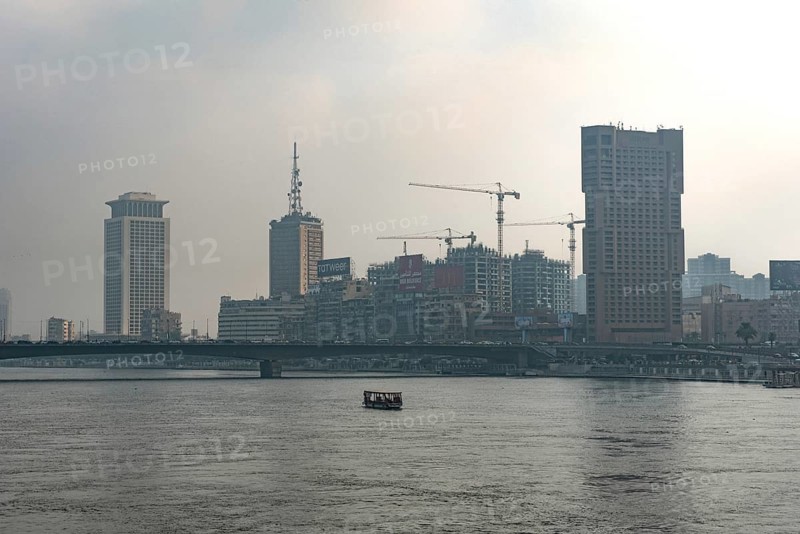 Cairo, Egypt. July 1st 2024 Building and construction cranes of the Cairo city skyline seen through hazy polluted air beside the River Nile, Egypt
