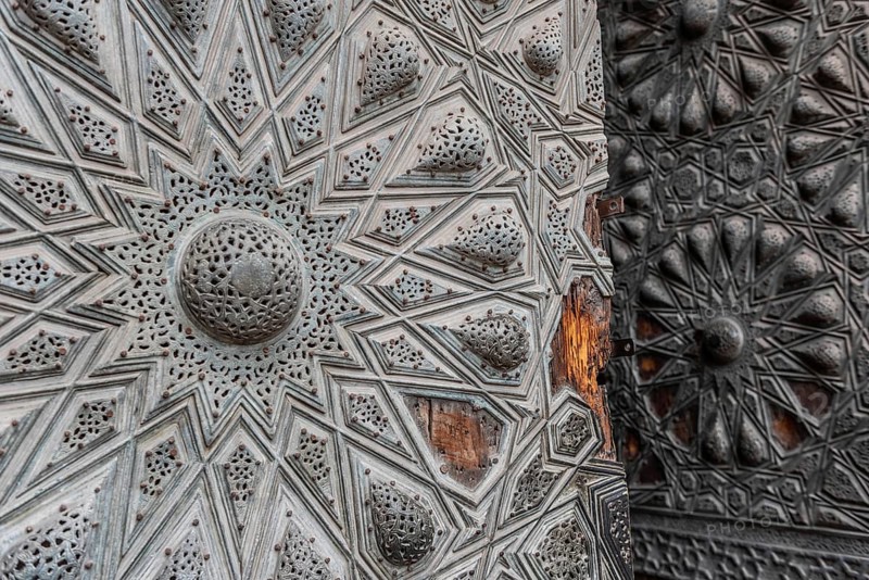 Beautiful Islamic geometric designed ancient wooden door of historical monument in the Egyptian city of Cairo. Art and design from Fatimid, Mamluk and Ottoman architecture