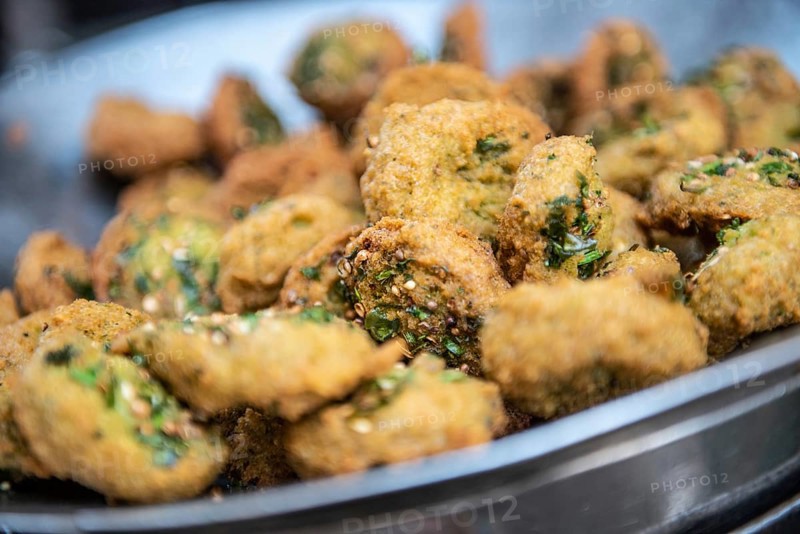 A close up detail of freshly cooked deep fried Falafel, a chickpea and herb filled snack popular in Egypt and all over the Middle East