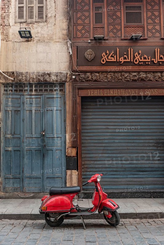 Cairo, Egypt, November 26th 2022 Very cool red Vespa motor scooter parked in the Islamic quarter of Cairo near the famous Khan el Khalili Bazaar, Egypt