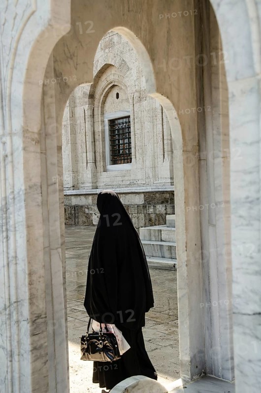 Bursa, Turkey. April 21st 2014 A Muslim women visiting the Grand Mosque of Bursa city in Turkey