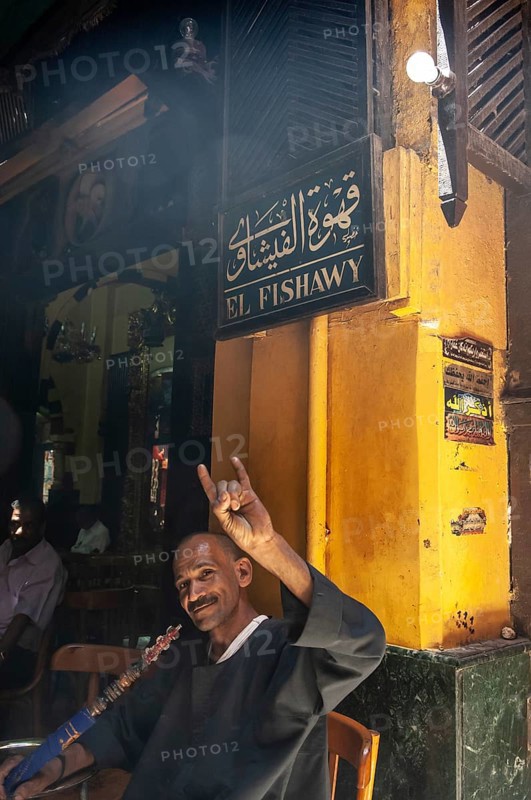 Cairo, Egypt. July 23rd 2011 An Egyptian man enjoying a shisha water pipe in the famous El Fishawy cafe, Khan el Khalili Bazaar, Cairo, Egypt