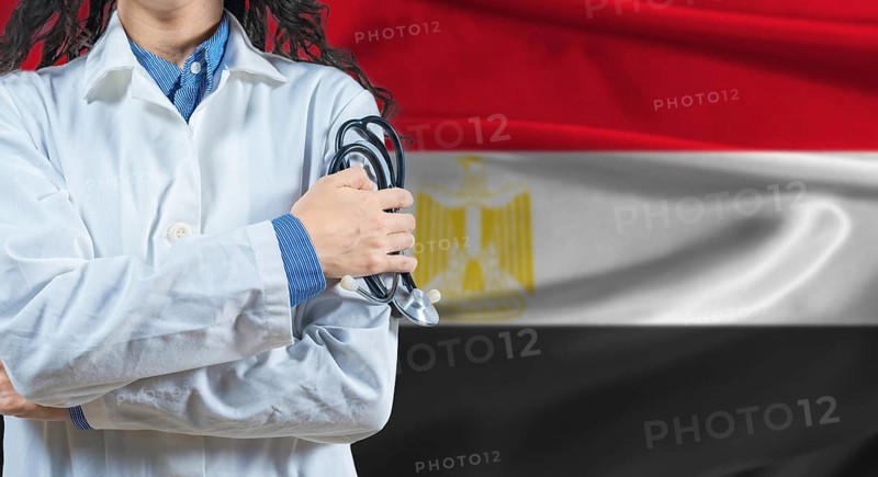 Healthcare professional with Egypt flag background. Professional doctor holding stethoscope on Egypt flag background