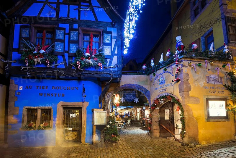 Colour-illuminated and Christmassy decorated half-timbered houses, blue hour, Christmas market, Riquewihr, Grand Est, Haut-Rhin, Alsace, France