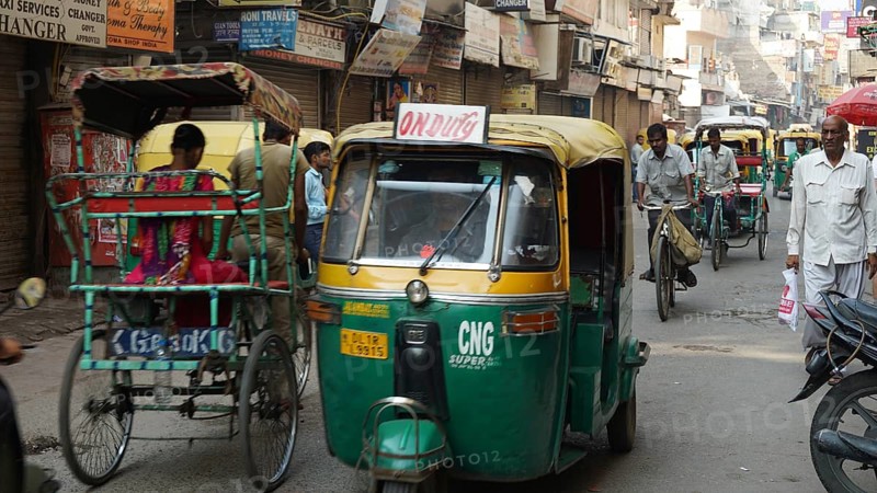 Busy street in India with rickshaws and people, dynamic city scene, Delhi