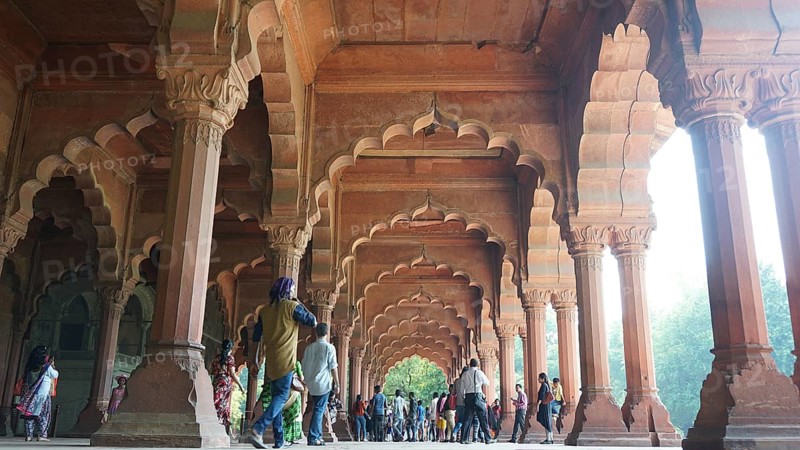 Red Fort in Delhi, historic arcades with imposing pillars and people below, Delhi, India