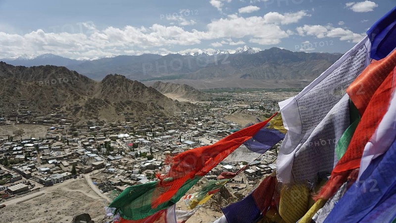 Colourful prayer flags fly over an expanding mountain town, Leh, Ladakh, North India, Himalayas, India